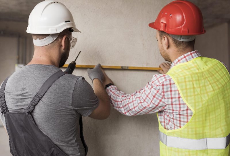 back-view-men-working-together